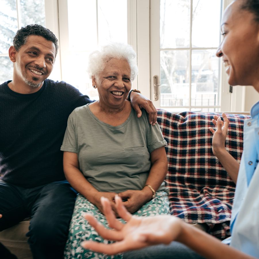 A family member embracing an elderly loved one at home