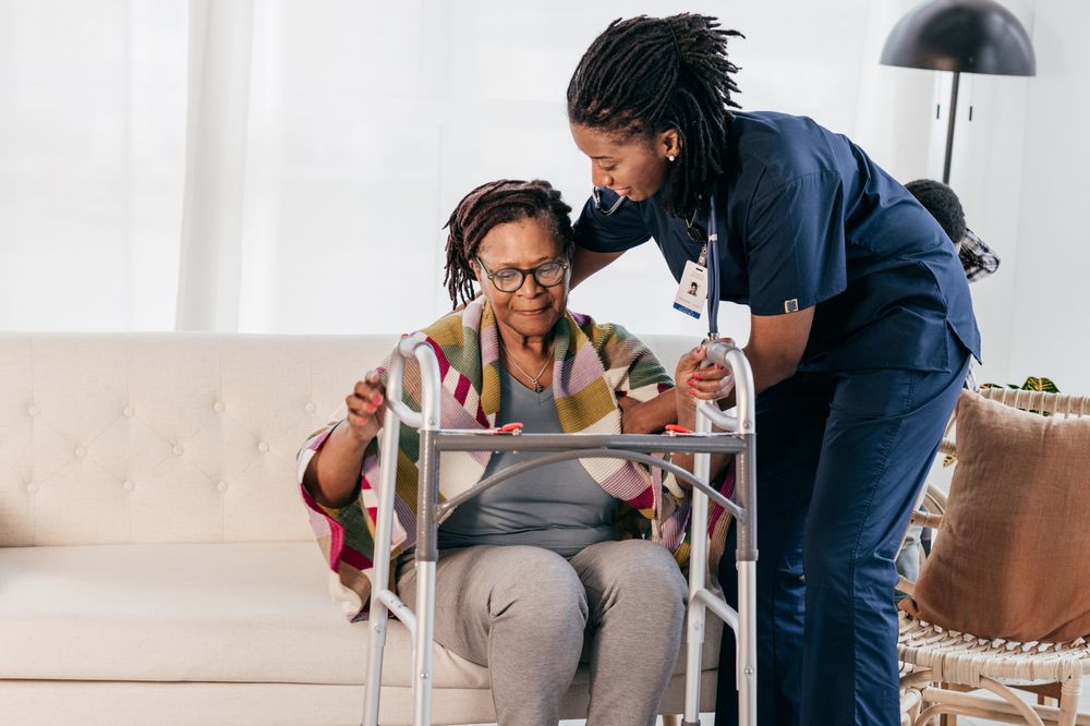 A caregiver assisting a client with mobility support indoors