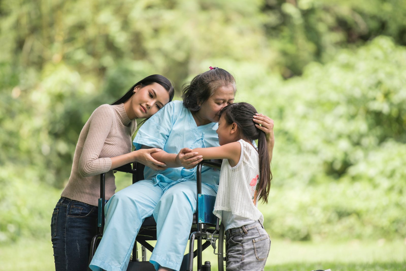 Happy grandmother in wheelchair with her daughter and grandchild